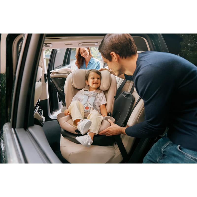 Cybex Callisto G 360° rotating all-in-one convertible car seat in ocean blue, with a happy child secured in the seat.