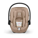 Cybex Cloud G Pro Comfort Extend Infant Car Seat in Almond Beige, featuring a padded design and adjustable harness system.
