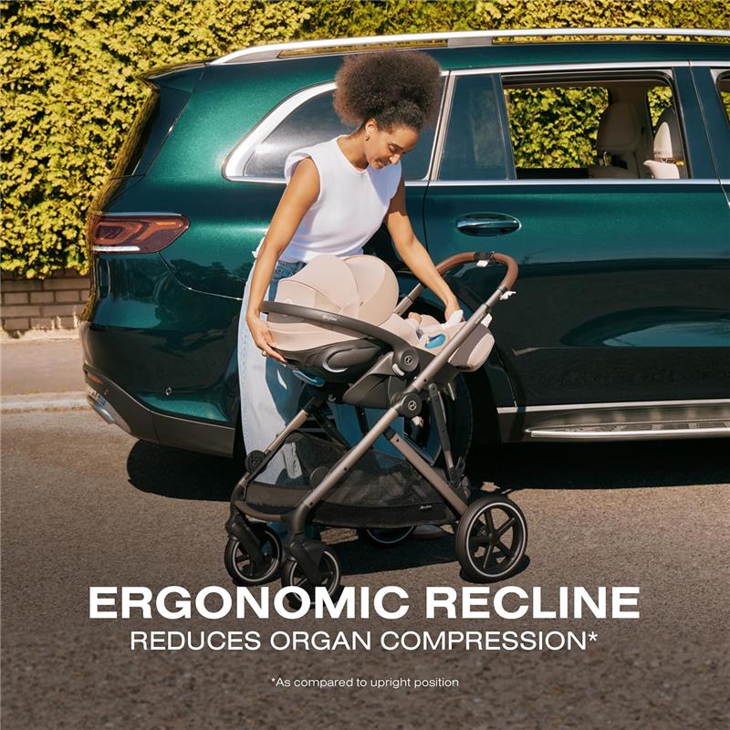 Cybex Cloud G Pro Comfort Extend Infant Car Seat in Ocean Blue, displayed in a stroller, held by a woman near a car.