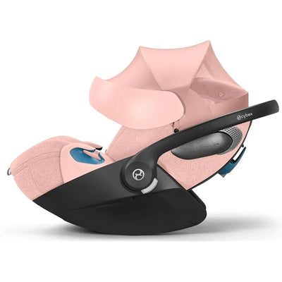 Cybex Cloud T Sensorsafe infant car seat in peach pink, featuring a sleek design and safety sensors.