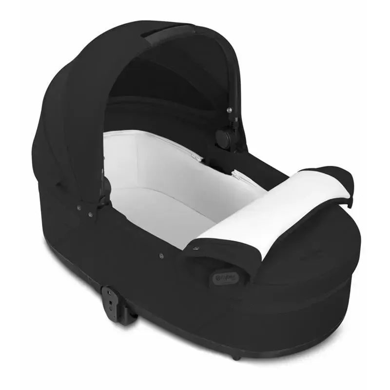 Cybex Cot S Lux 2 in Moon Black, featuring a sleek black exterior and a plush white interior.