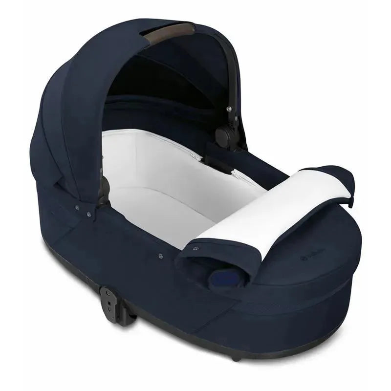 Cybex Cot S Lux 2 in Ocean Blue, featuring a durable fabric exterior with a white interior and a sturdy handle.