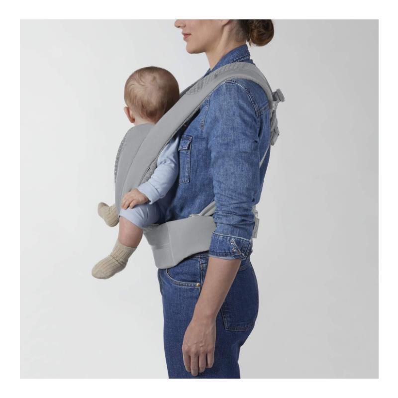 Cybex Coya Carrier in Thunder Grey worn by a woman carrying a baby on her front, both facing forward.