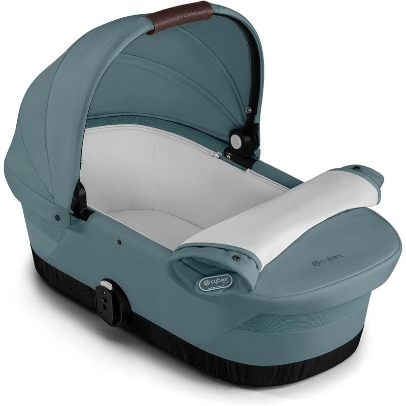 CYBEX eGazelle/Gazelle S cot bassinet in stormy blue, featuring a soft interior and adjustable canopy.