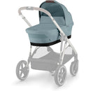 CYBEX eGazelle/Gazelle S Cot Bassinet in Stormy Blue attached to a stroller frame, featuring a soft fabric and sleek design.
