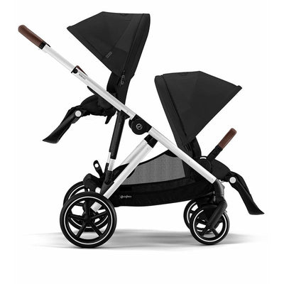 Cybex Gazelle S 2 Double Stroller in Moon Black with a silver frame and two adjustable canopies, showcasing its modern design.