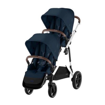 Cybex Gazelle S 2 Double Stroller Bundle in Ocean Blue with silver frame and brown handles, featuring two seats and a storage basket.
