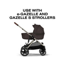 Cybex Gazelle S Cot in chocolate brown, designed for e-Gazelle and Gazelle S strollers, showcasing its foldable feature.