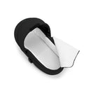 Foldable Cybex Gazelle S Cot in Moon Black with a white interior, designed for infant transportation.