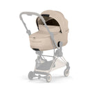 Cybex Mios/Coya Fold Lux Carry Cot in Cozy Beige, featuring a soft exterior, zippered compartment, and a sleek stroller attachment.