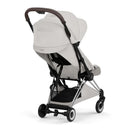 Cybex Platinum Coya stroller in City Grey with a chrome frame, showing a compact fold and adjustable canopy.