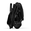 Cybex Platinum Coya Stroller in a compact, folded position, featuring a matte black frame and sepia black lux seat.