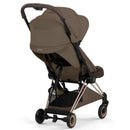 Cybex Platinum Coya stroller in coconut brown with a rose gold frame, angled view showing the seat and canopy.