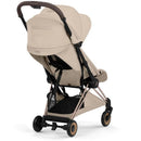 Cybex Platinum Coya Stroller in Cozy Beige with a rose gold frame, featuring a collapsible design and adjustable seat.