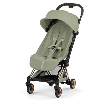 Cybex Platinum Coya stroller in sage green with a rose gold frame, featuring a reclining seat and safety harness.