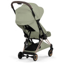 Cybex Platinum Coya stroller featuring a rose gold frame and sage green lux seat, shown from the rear angle.