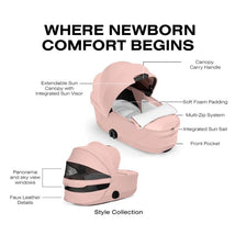 Cybex Priam Fold Carrycot in peach pink with extendable sun canopy, soft foam padding, front pocket, and panoramic windows.
