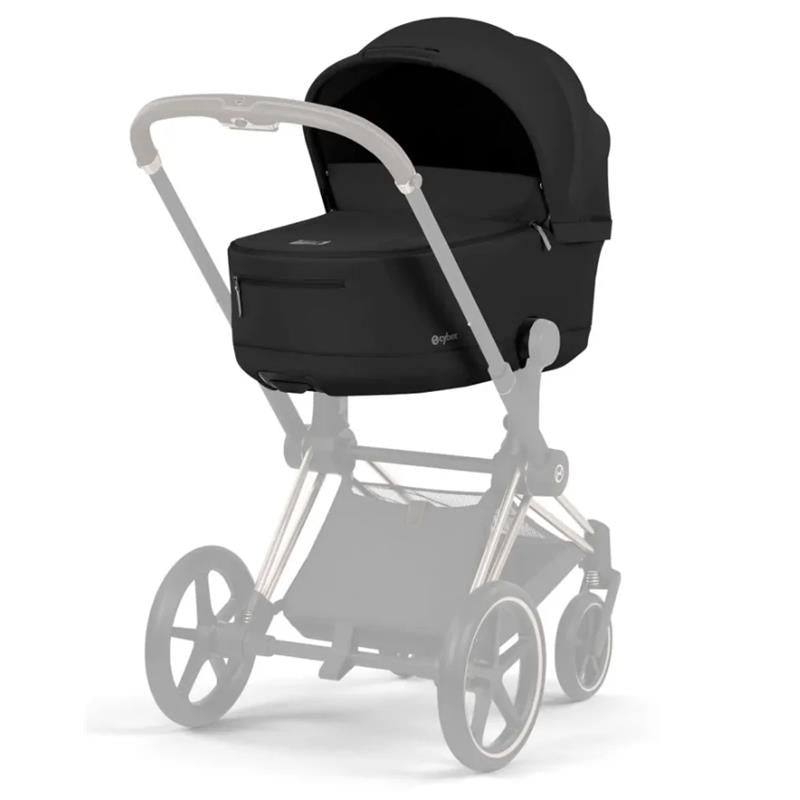 Cybex Priam Fold Lux Carry Cot in sepia black, showcasing a sleek design with a large canopy and zippered compartment.
