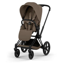 Cybex Priam stroller with a matte black frame and coconut brown lux seat, designed for infants and toddlers.