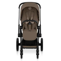 Cybex Priam stroller with a matte black frame and coconut brown lux seat, featuring a safety harness and spacious seat.