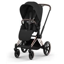 Cybex Priam stroller with a rose gold frame and sepia black lux seat, featuring a folding canopy and comfortable harness.