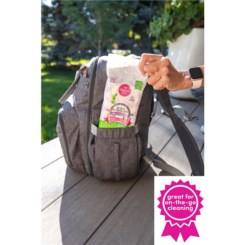 Dapple all-purpose wipes in lavender scent, packaged for on-the-go use, being taken from a backpack.