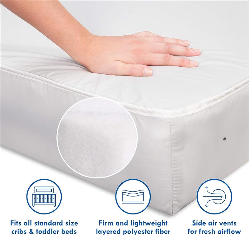 Complete Slumber Crib & Toddler Mattress with a hand pressing on a firm, white surface; features side air vents and layered polyester fiber.