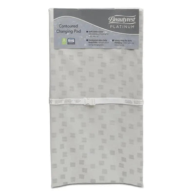 Waterproof contoured changing pad by Delta Children with soft fabric cover and safety strap for baby security.