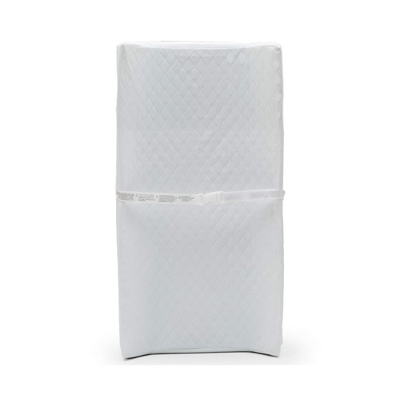 Contoured changing pad in white, featuring a quilted surface and secured with a safety strap.