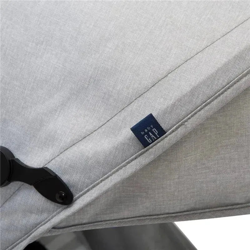 Light grey canopy of the Delta Gap Classic Umbrella Lightweight Stroller with a visible blue Baby Gap tag.