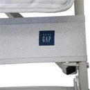 Grey fabric detail of the Delta - Gap Classic Umbrella Lightweight Stroller, featuring the baby GAP logo.