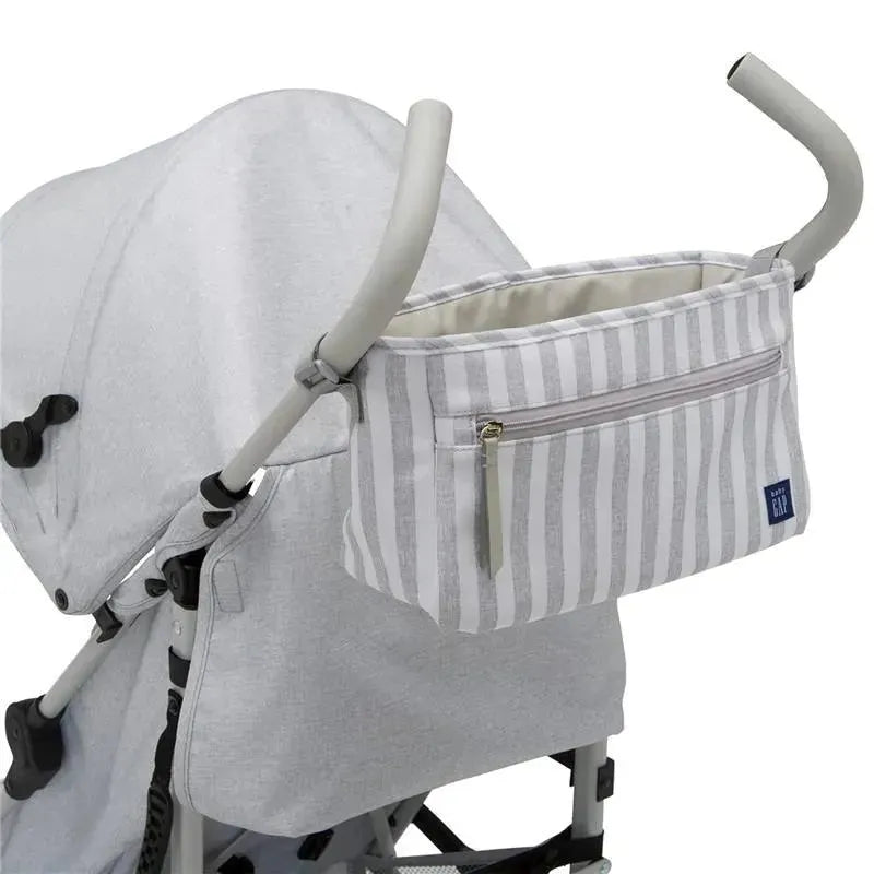 Grey Delta - Gap Classic Umbrella Lightweight Stroller with a striped storage pouch attached to the handles.