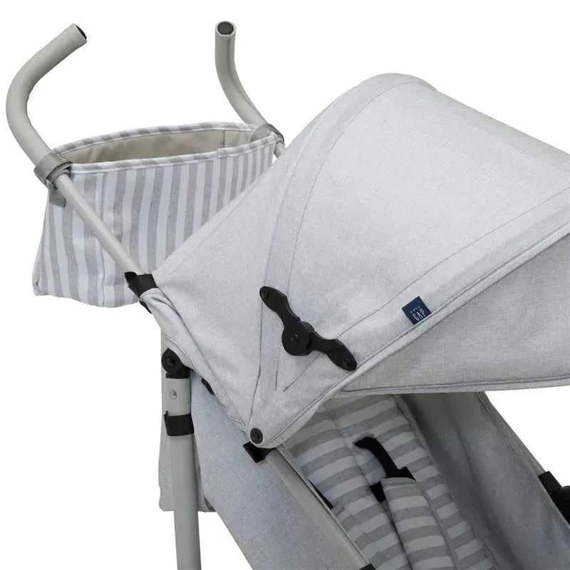 Lightweight grey umbrella stroller featuring a canopy, adjustable handle, and striped storage basket.