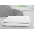 White Delta Sertapedic fitted crib mattress pad folded neatly on a gray surface, showcasing a quilted texture.