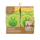 Green and yellow dinosaur-themed knee pads for infants, featuring a smiling dinosaur face and protective padding.