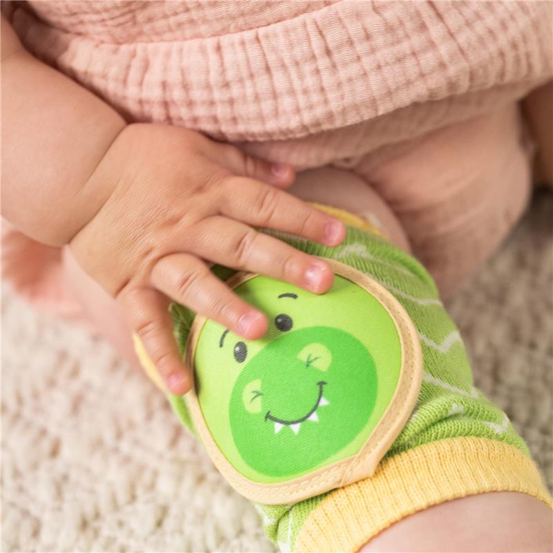 Green and yellow dinosaur-themed knee pads with a smiling dino face, worn by an infant.