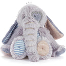 Soft, plush elephant toy in shades of gray and pastel, featuring a heart design on its cheek and textured patches.