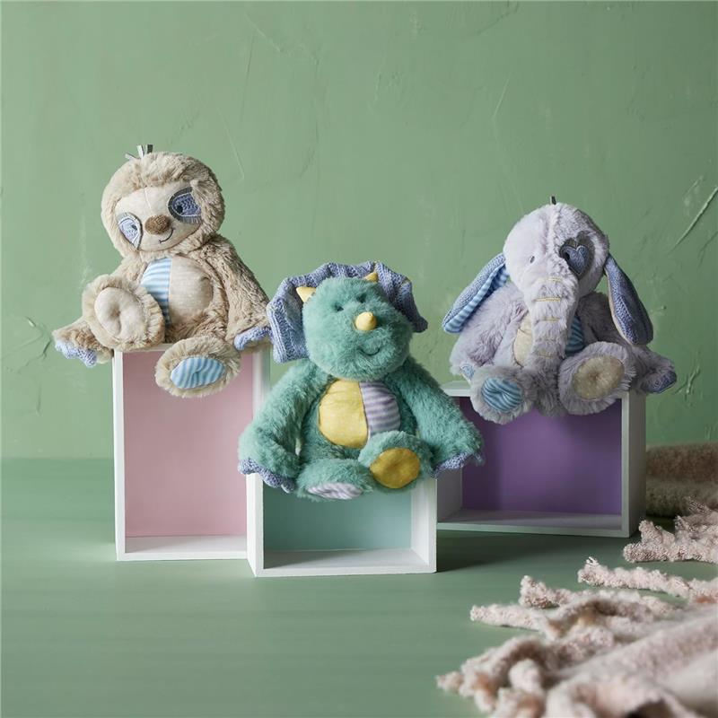 Soft plush toys in assorted colors: a sloth, elephant, and dinosaur, displayed in white wooden boxes against a green background.