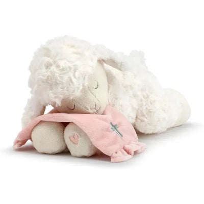 Soft white lamb plush with a pink blanket and a cross design, perfect for comforting children at bedtime.
