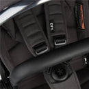 DFY - R1 Single Stroller in black, featuring padded seat, adjustable harness, and safety warning tag.