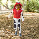 Deluxe Paw Patrol Marshall toddler costume featuring a child in a red vest, spotted pants, and a matching hat in a leafy setting.