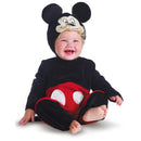Infant wearing a black and red Mickey Mouse costume with a soft hat, smiling while sitting on the floor.