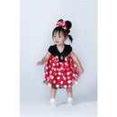 Toddler in a red and white polka dot Minnie Mouse costume with a black top and matching bow, smiling.