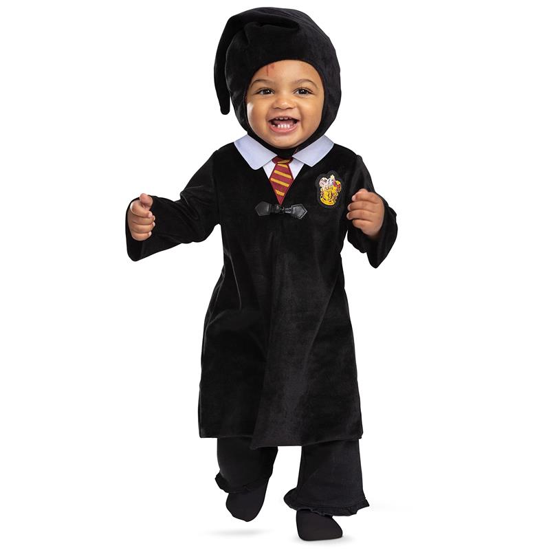 Toddler wearing a black Harry Potter costume with a Gryffindor emblem and a wizard hat, smiling and playing.