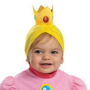 Infant wearing a pink dress with puffy sleeves and a yellow crown headband, smiling and showcasing the Princess Peach costume.