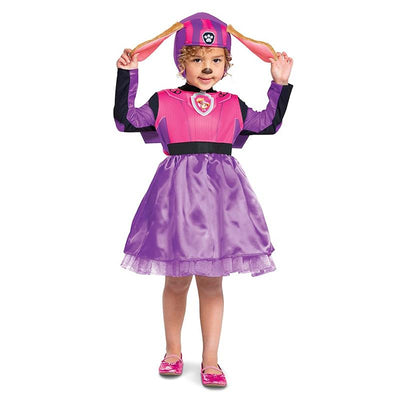 Toddler wearing a pink Paw Patrol Skye costume with a dress and hat featuring dog ears, smiling and posing.