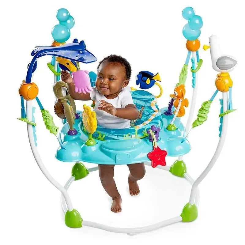 Baby playing joyfully in a Disney Baby Finding Nemo Sea of Activities Jumper with colorful sea creature toys.