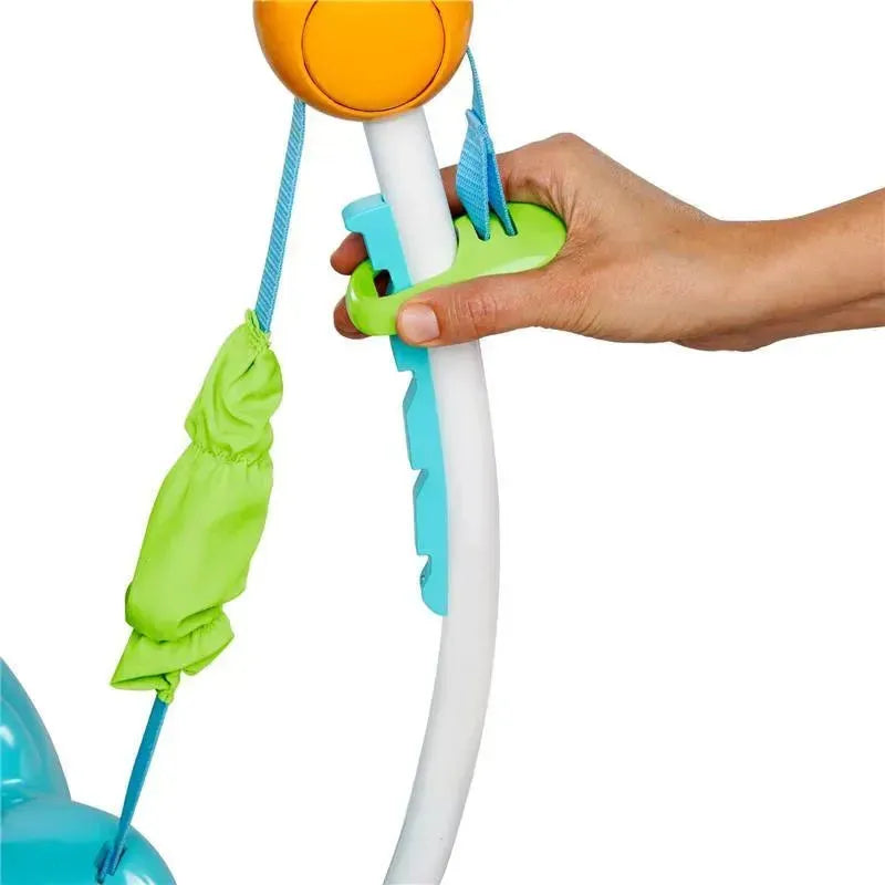 Hand adjusting a feature on the Disney Baby Finding Nemo Sea of Activities Jumper, showcasing colorful components and fabrics.
