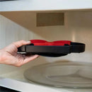 Disney Baby Silicone Grip Dish in black and red, held above a microwave, designed for young children.
