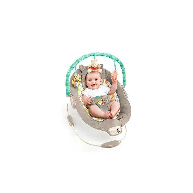 Disney Baby Winnie The Pooh Bouncer featuring a smiling baby, playful toys, and a soft, cushioned seat.